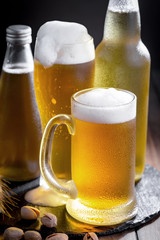 Light beer in a glass on a table in composition with accessories on an old background