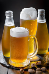 Light beer in a glass on a table in composition with accessories on an old background