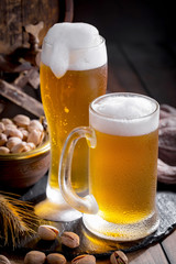 Light beer in a glass on a table in composition with accessories on an old background