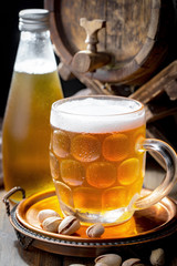 Light beer in a glass on a table in composition with accessories on an old background