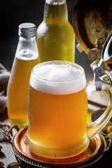 Light beer in a glass on a table in composition with accessories on an old background