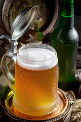 Light beer in a glass on a table in composition with accessories on an old background