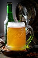 Light beer in a glass, on an old background. 