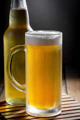 Light beer in a glass, on an old background.