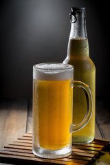 Light beer in a glass, on an old background. 