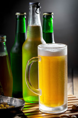 Light beer in a glass on a table in composition with accessories on an old background