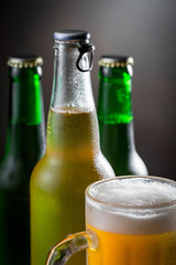 Light beer in a glass on a table in composition with accessories on an old background