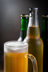 Light beer in a glass on a table in composition with accessories on an old background