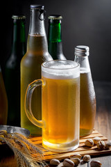 Light beer in a glass, on an old background.