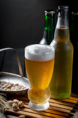 Light beer in a glass, on an old background.