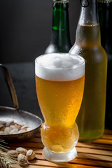 Light beer in a glass, on an old background.
