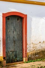 Old wooden door in a house with colonial architecture worn by time in the city of Tiradentes, state of Minas Gerais