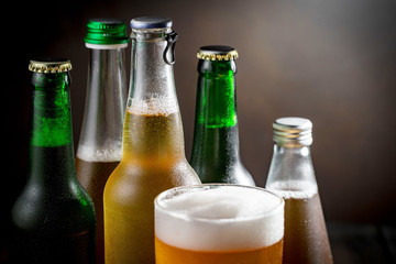 Light beer in a glass on a table in composition with accessories on an old background