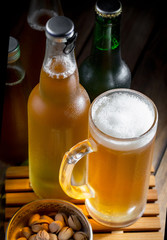 Light frothing beer in a glass, on an old background.