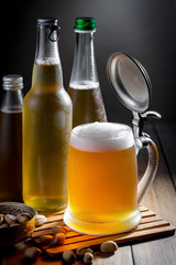 Light beer in a glass, on an old background.