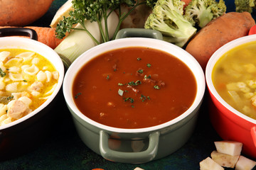 Set of soups from worldwide cuisines, healthy food. Broth with noodles, beef soup and broth with marrow dumplings. All soups with healthy vegetables on table