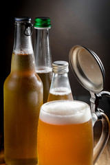 Light beer in a glass on a table in composition with accessories on an old background