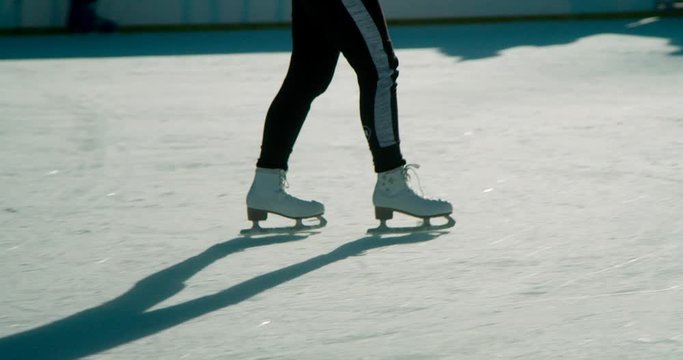 A Girl Skating With A Free Style Movement In The Ice Surface With Her Friends During Sunny Day - Wide Shot