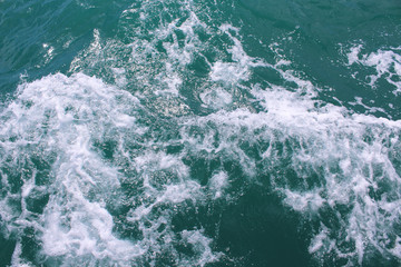 Wake jet left from a boat at sea. Trail on the water from the ship. Close-up. Background. Texture.