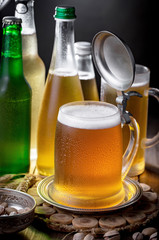 Light beer in a glass on a table in composition with accessories on an old background