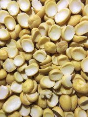 Yellow split dried peas background. Vertical. Close up.