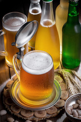 Light beer in a glass on a table in composition with accessories on an old background