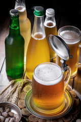 Light beer in a glass on a table in composition with accessories on an old background