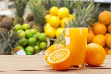 Orange juice in glass and slices of orange fruit