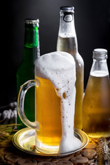 Light beer in a glass on a table in composition with accessories on an old background