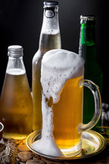 Light frothing beer in a glass, on an old background.