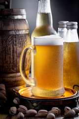 Light beer in a glass, on an old background.