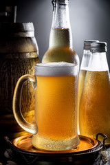 Light beer in a glass on a table in composition with accessories on an old background