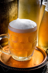 Light beer in a glass on a table in composition with accessories on an old background