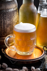 Light beer in a glass on a table in composition with accessories on an old background