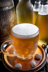 Light beer in a glass on a table in composition with accessories on an old background