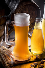 Light beer in a glass on a table in composition with accessories on an old background