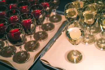Servings of red and white wine on separate trays
