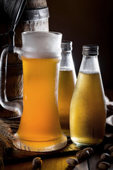 Light beer in a glass on a table in composition with accessories on an old background