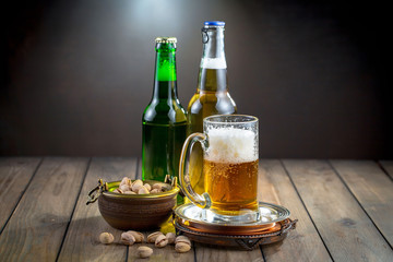 Light beer in a glass on a table in composition with accessories on an old background