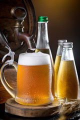 Light beer in a glass on a table in composition with accessories on an old background
