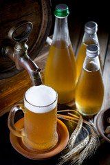 Light frothing beer in a glass, on an old background.