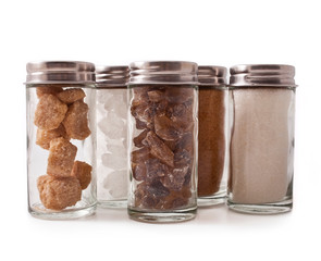 Different sugar in a glass container isolated on a white background.