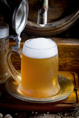 Light beer in a glass on a table in composition with accessories on an old background
