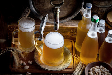Light beer in a glass on a table in composition with accessories on an old background