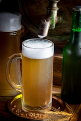 Light beer in a glass, on an old background.