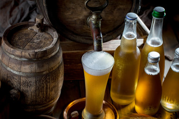 Light beer in a glass, on an old background.