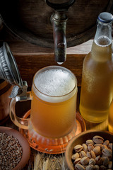 Light beer in a glass on a table in composition with accessories on an old background