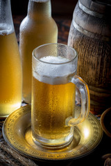 Light beer in a glass on a table in composition with accessories on an old background