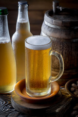 Light beer in a glass, on an old background.