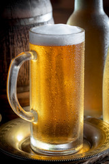 Light beer in a glass, on an old background.